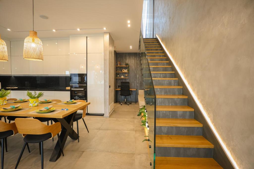 a dining room with a table and a staircase at Green Coast Resort V94 in Palasë