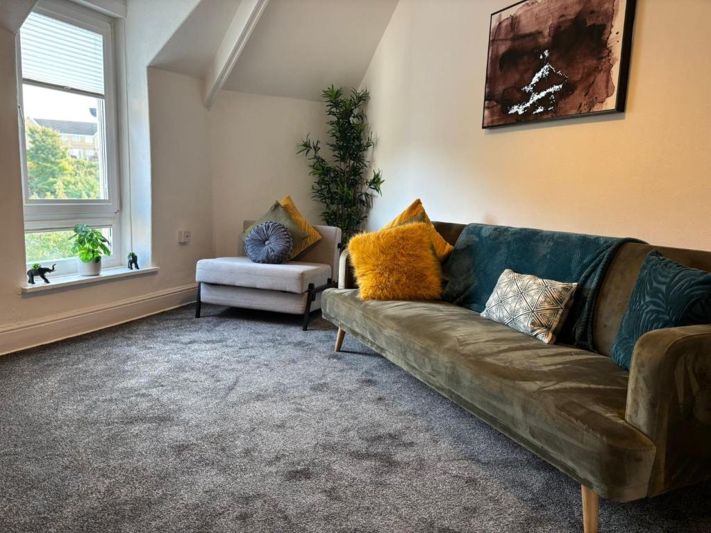 a living room with a couch and a chair at Island Heights By MGroupSA in Barry