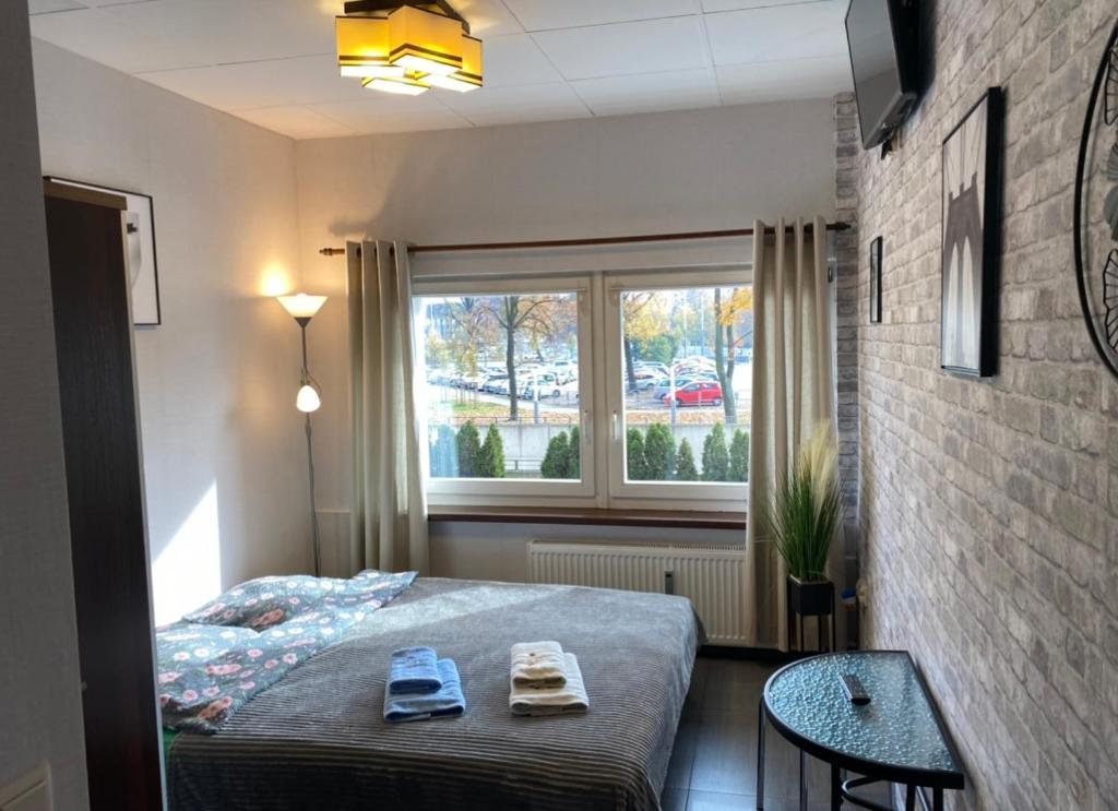 Posteľ alebo postele v izbe v ubytovaní Aparthotel Superjednostka Katowice