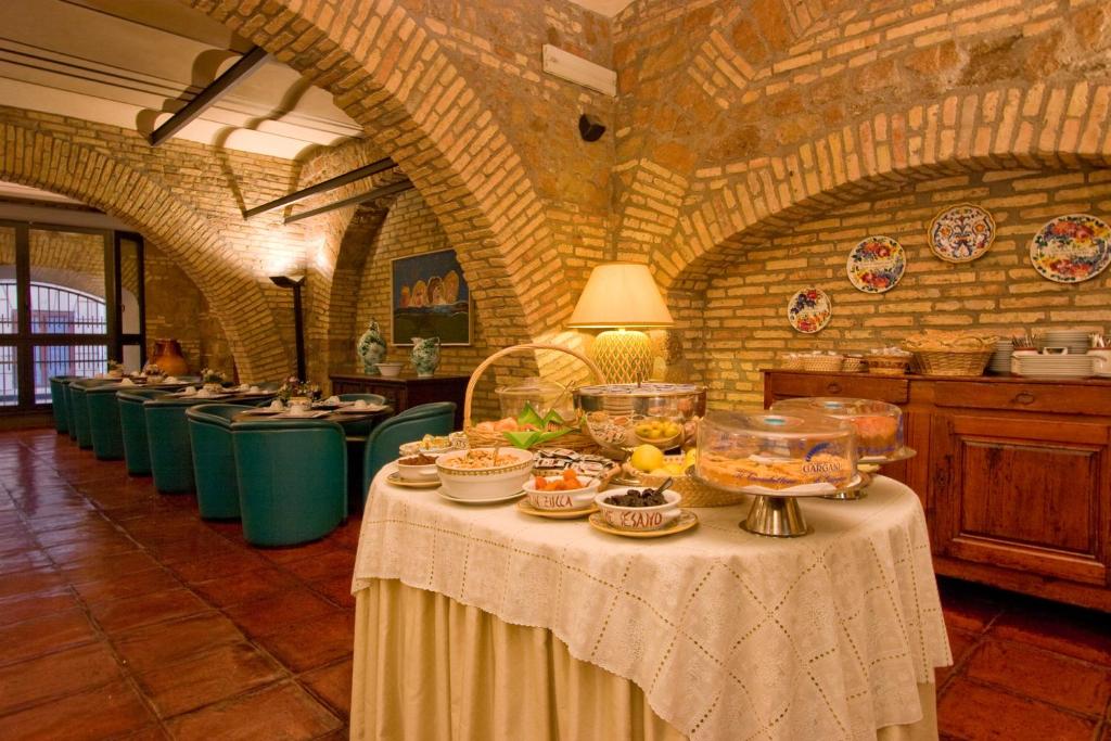 a room with a table with bowls of food on it at Hotel Laurentia in Rome