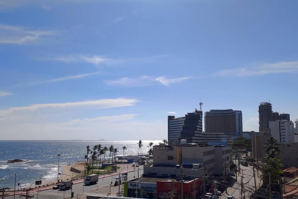 a view of a beach with buildings and the ocean at Ondina Flat 413 in Salvador