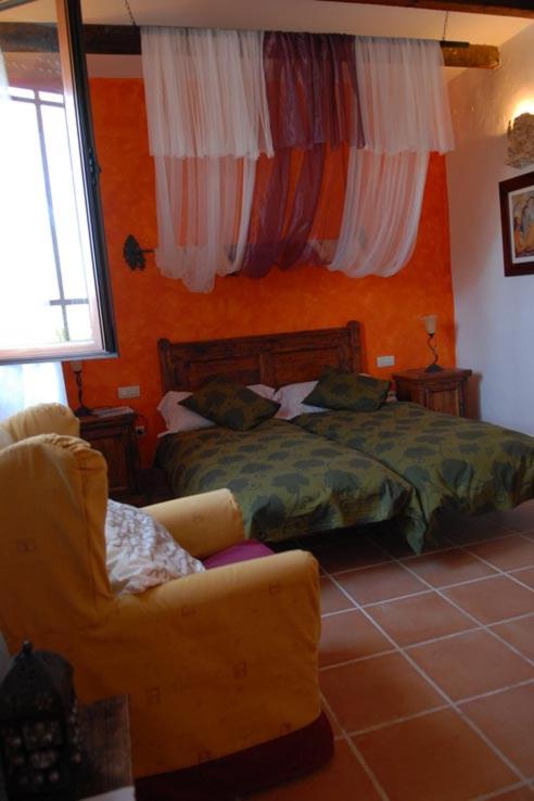 A bed or beds in a room at La Venta de las Estrellas Casas Rurales
