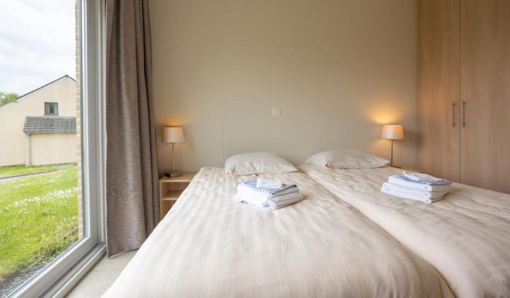 Postel nebo postele na pokoji v ubytování Holiday Park La Sapinière