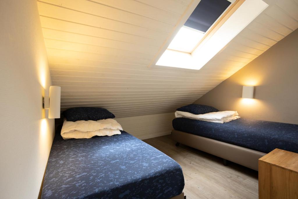 Postel nebo postele na pokoji v ubytování Holiday Park La Sapinière