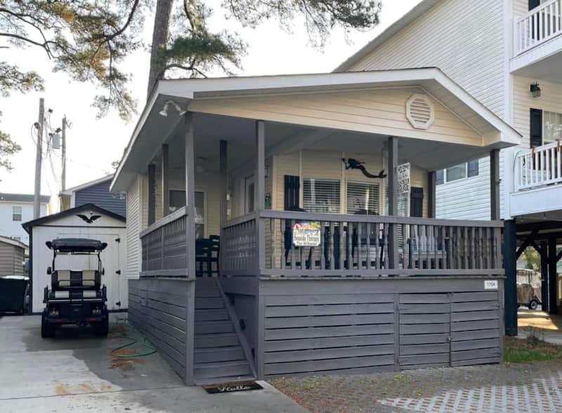 a house with a large porch with a deck at Seaside Therapy in Myrtle Beach