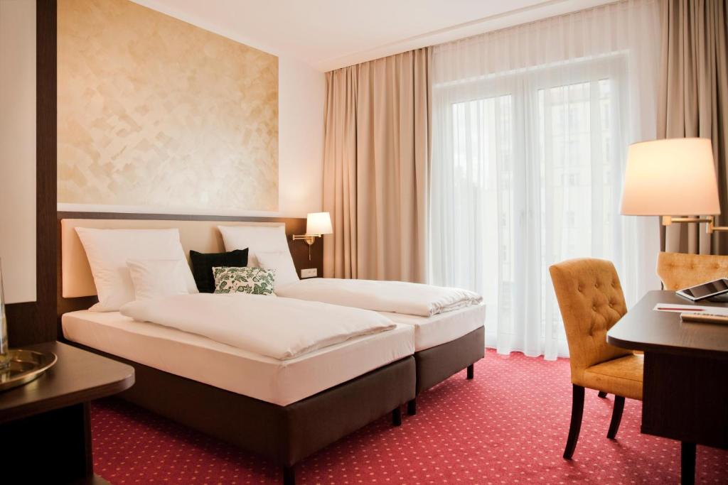 Postel nebo postele na pokoji v ubytování Gold Palais Hotel