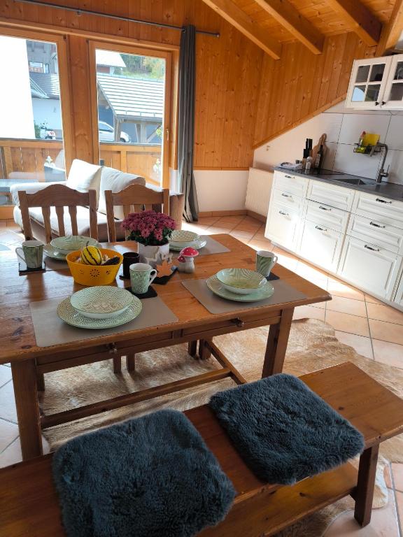 a wooden table with plates on it in a kitchen at Ferienwohnung Fleur in Bad Kohlgrub