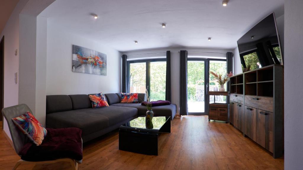 a living room with a couch and a table at Ferienwohnung-Claudia in Schwerin in Schwerin