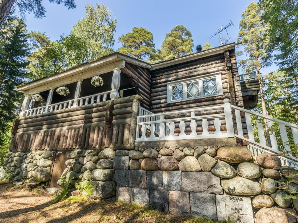 a log cabin on a rock wall at Holiday Home Villa kallahti beach view helsinki by Interhome in Helsinki