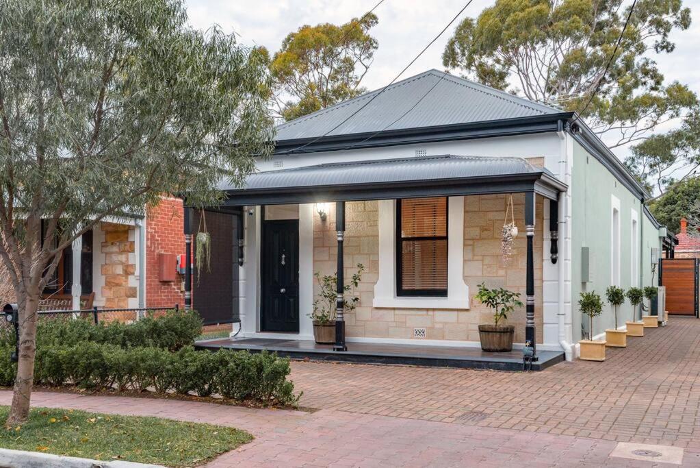 a house on a street with a brick driveway at Essex Cottage with garden, 2BR, near Adelaide Showground in Wayville