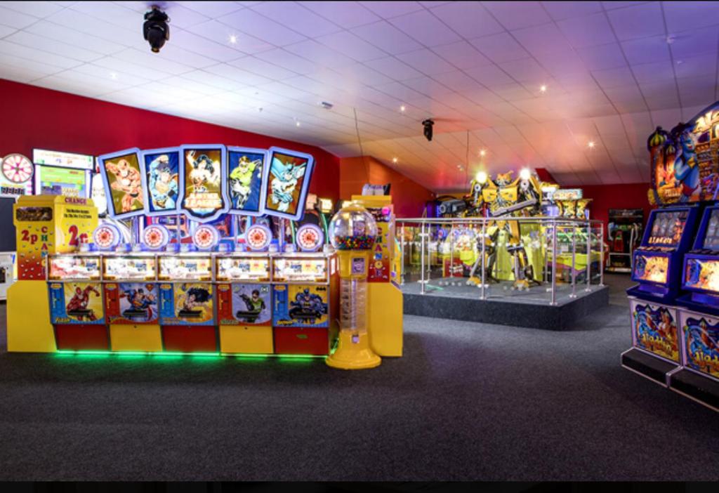 a gaming room with many arcade games and machines at Tucker’s Retreat in Dymchurch