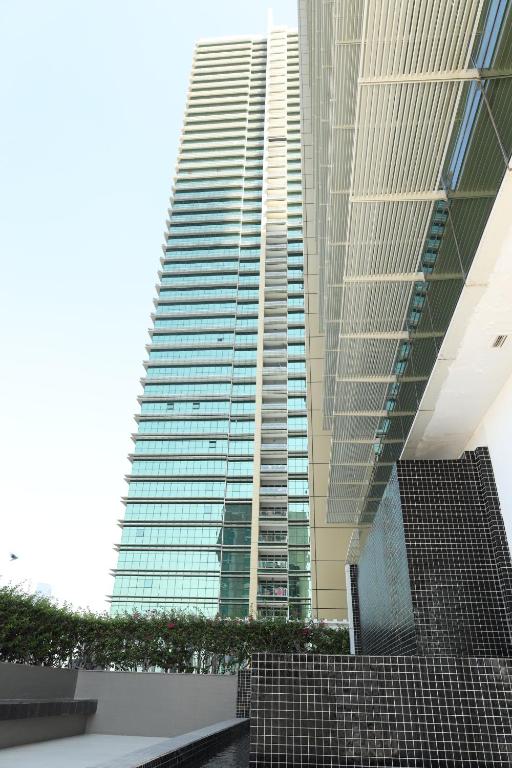 a tall building with a staircase in front of it at Delmon دلمون in Abu Dhabi