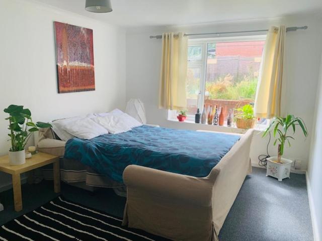 a bedroom with a bed and a window at Bramley Fall Park Homestay in Horsforth