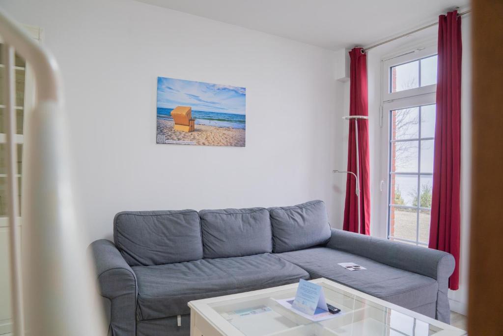a living room with a couch and a table at Schleiblick App 12 in Rabenkirchen-Faulück