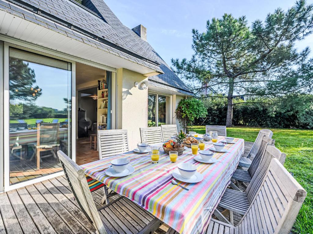 a table with plates of food on it on a patio at Holiday Home Le Prado-1 by Interhome in Saint-Philibert