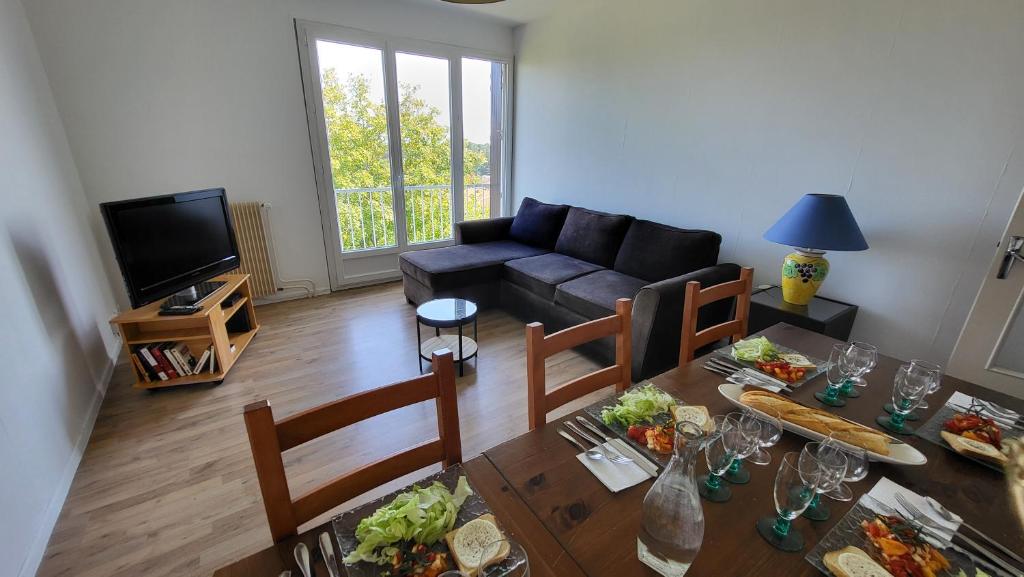 un salon avec une table avec de la nourriture dessus dans l'établissement T3 With 2 Loggias And Parking Tournus Center, à Tournus