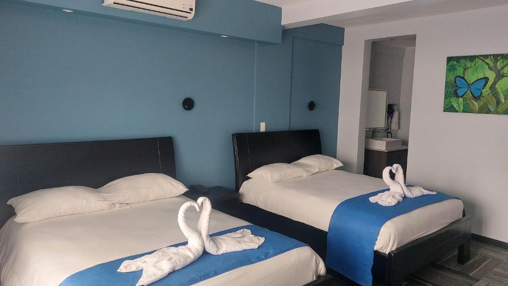 Postel nebo postele na pokoji v ubytování Hotel Luckys