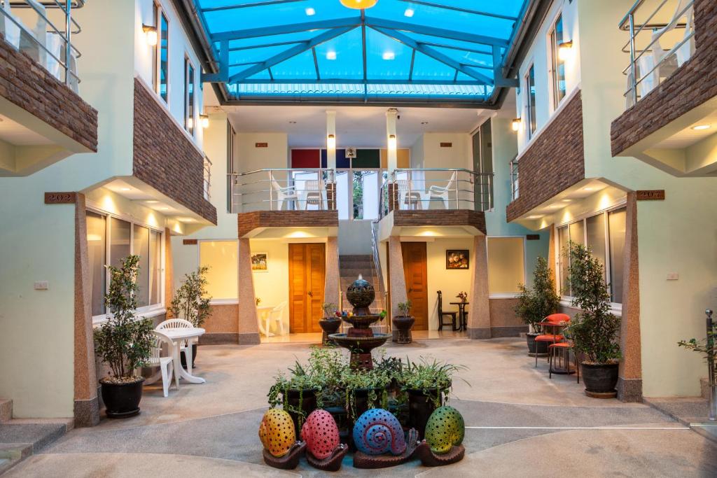 arium of a building with a fountain and plants at Fahsai Bay Villa in Ao Nam Mao