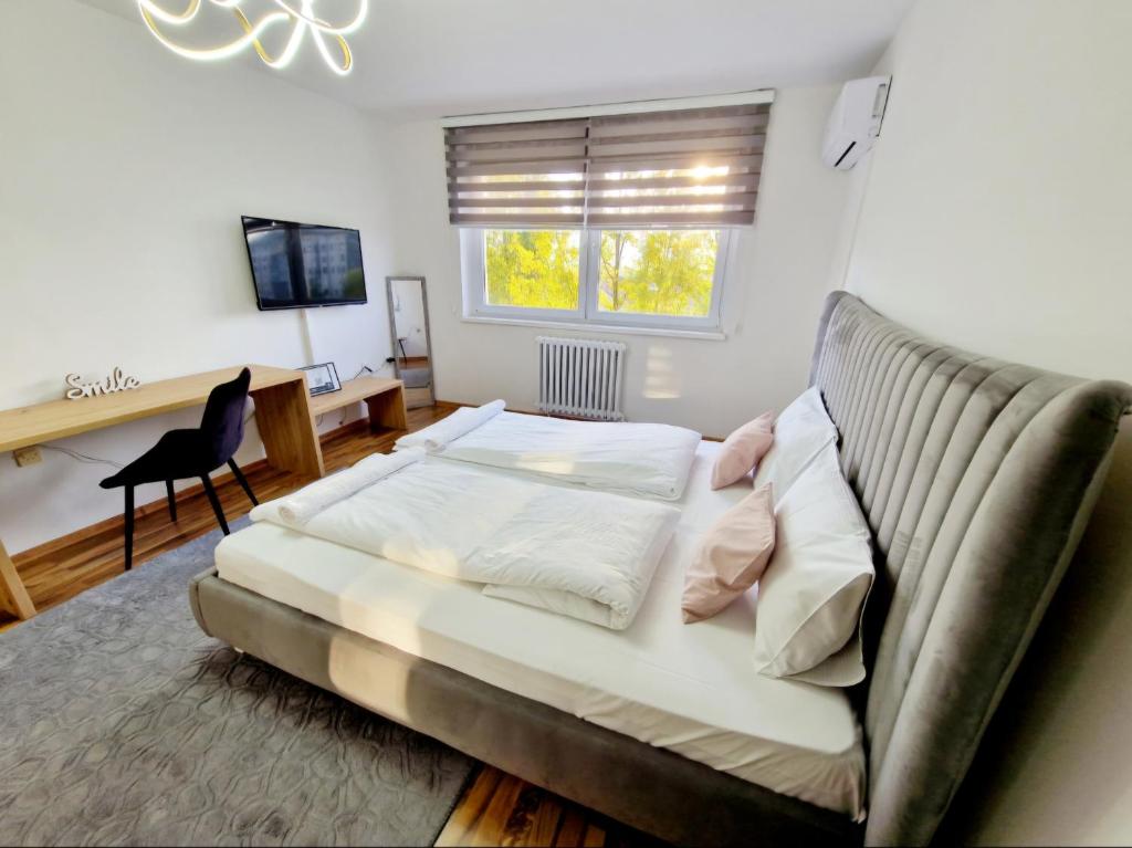 a bed in a room with a couch and a desk at Infinity Apartment & Free Wifi & Free Parking in Sarajevo