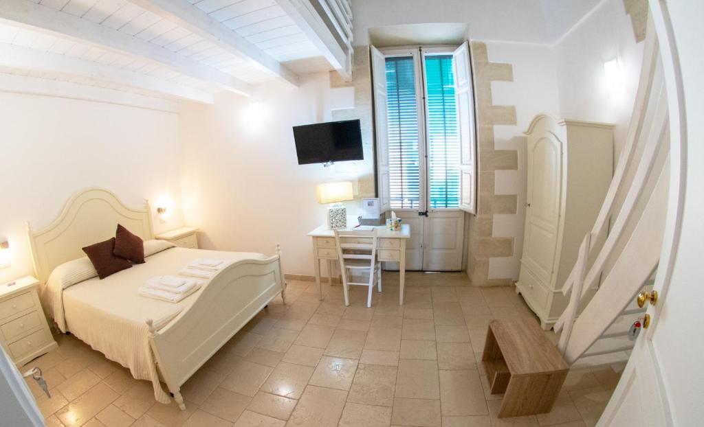 Postel nebo postele na pokoji v ubytování Palazzo Vilei