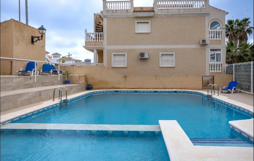 a swimming pool in front of a building at Orihuela Costa Sleeps 6 with Roof Terrace & Pool in Villacosta