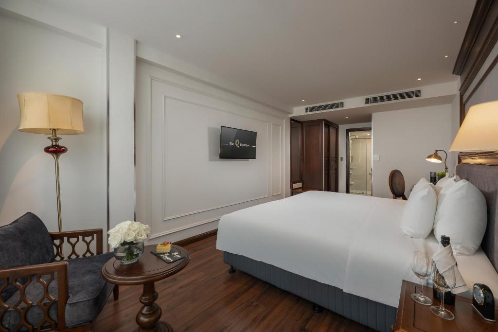 Postel nebo postele na pokoji v ubytování The Q Boutique Hotel