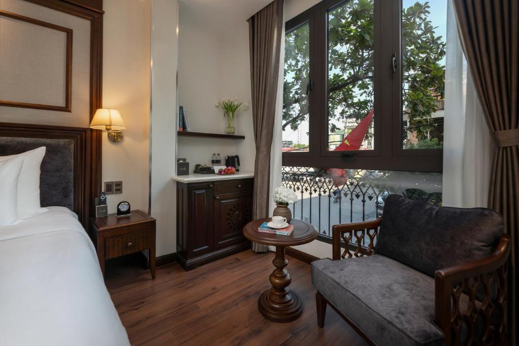 Postel nebo postele na pokoji v ubytování The Q Boutique Hotel
