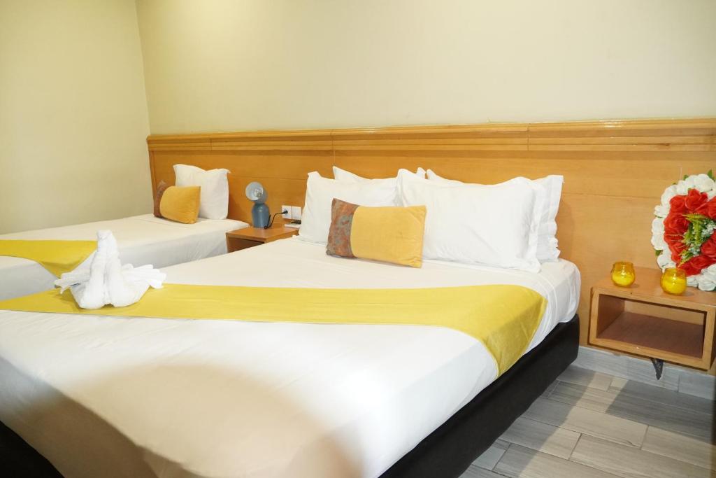 Postel nebo postele na pokoji v ubytování Hotel Golden Flora