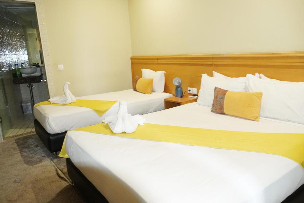 Postel nebo postele na pokoji v ubytování Hotel Golden Flora