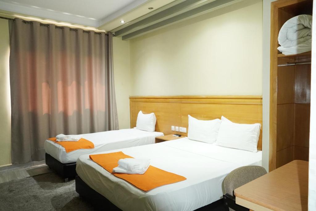 Postel nebo postele na pokoji v ubytování Hotel Golden Flora