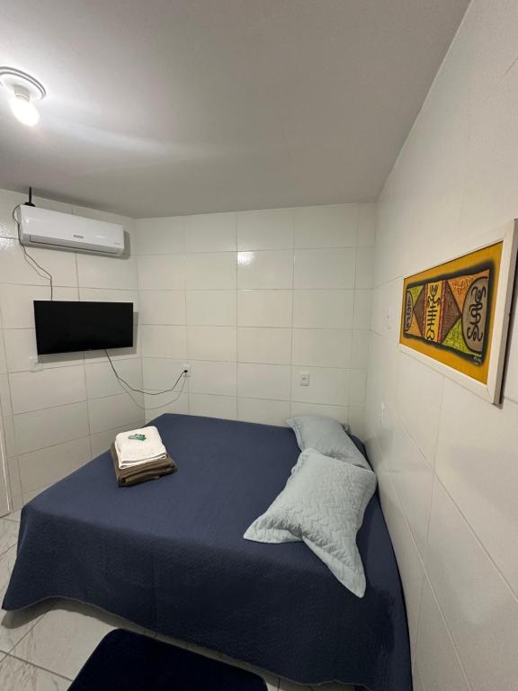 Postel nebo postele na pokoji v ubytování Cantinho Aconchegante- Quarto 03 Família - com AR