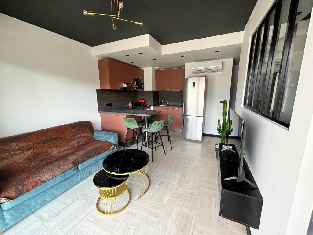 a living room with a bed and a kitchen at Cosy 2p in Cagnes-sur-Mer