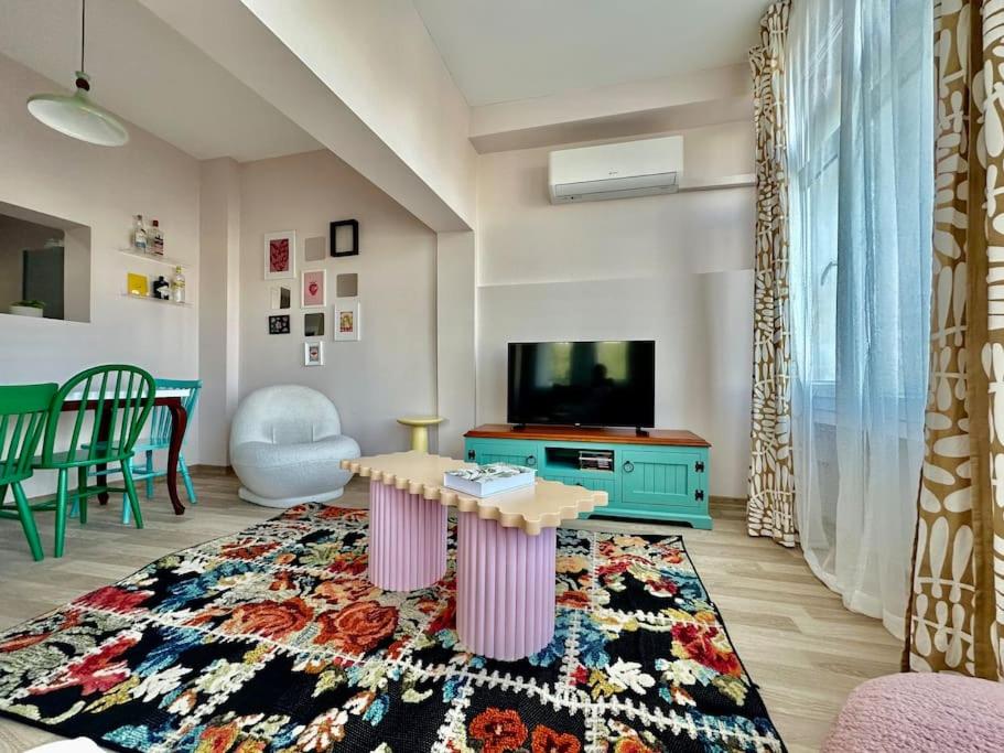 a living room with a table and a tv at ALICE Daire in Konak
