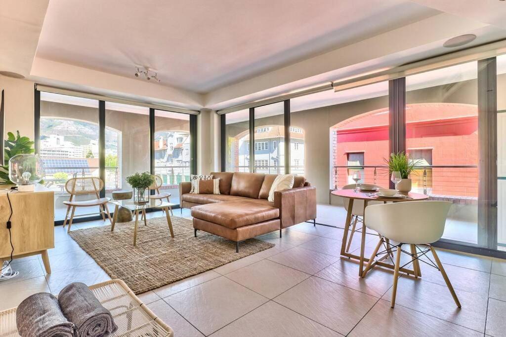 a living room with a couch and a table at The Rockwell Apt in DeWaterkant next to Waterfront in Cape Town