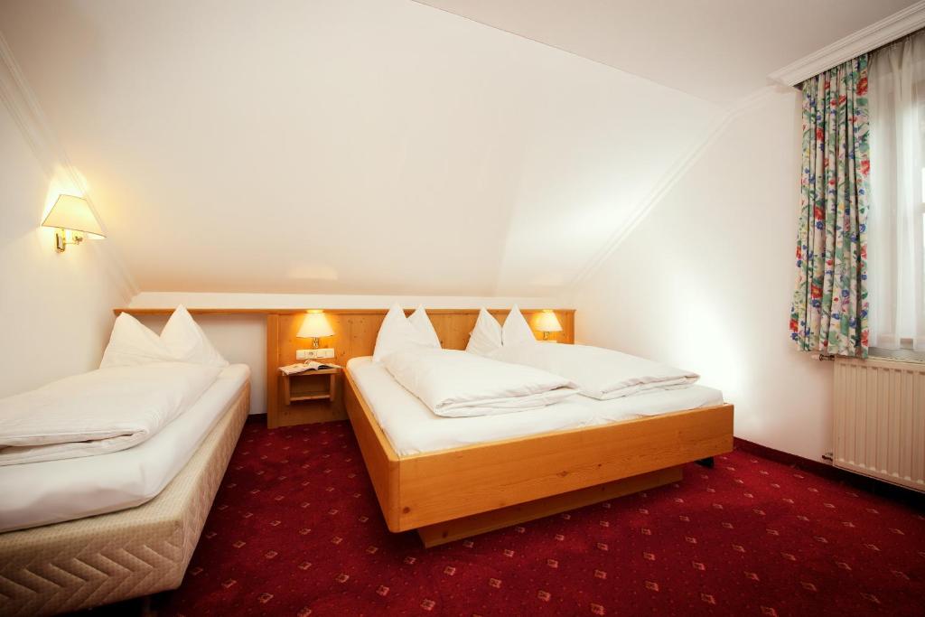 Postel nebo postele na pokoji v ubytování Hotel Grafenwirt