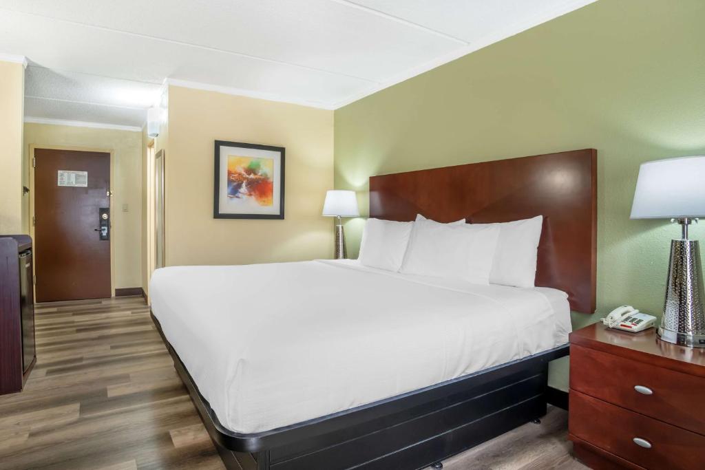 a hotel room with a large bed and a telephone at Best Western Charlotte-Gastonia in Gastonia