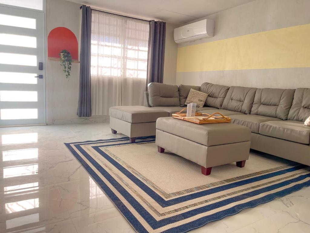 a living room with a couch and a coffee table at Relaxing Retreat for 5 Close to Beach & Airport in Carolina