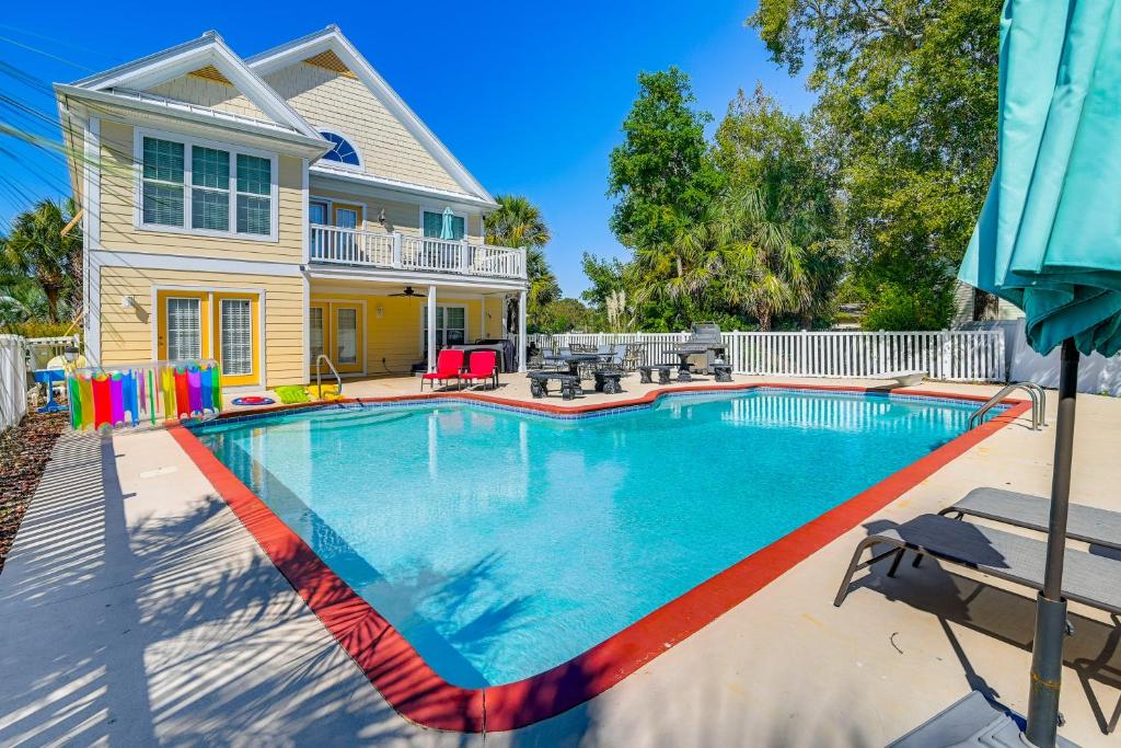 a swimming pool in front of a house at 1 Mi to Beach and Hot Tub Murrells Inlet Retreat! in Myrtle Beach