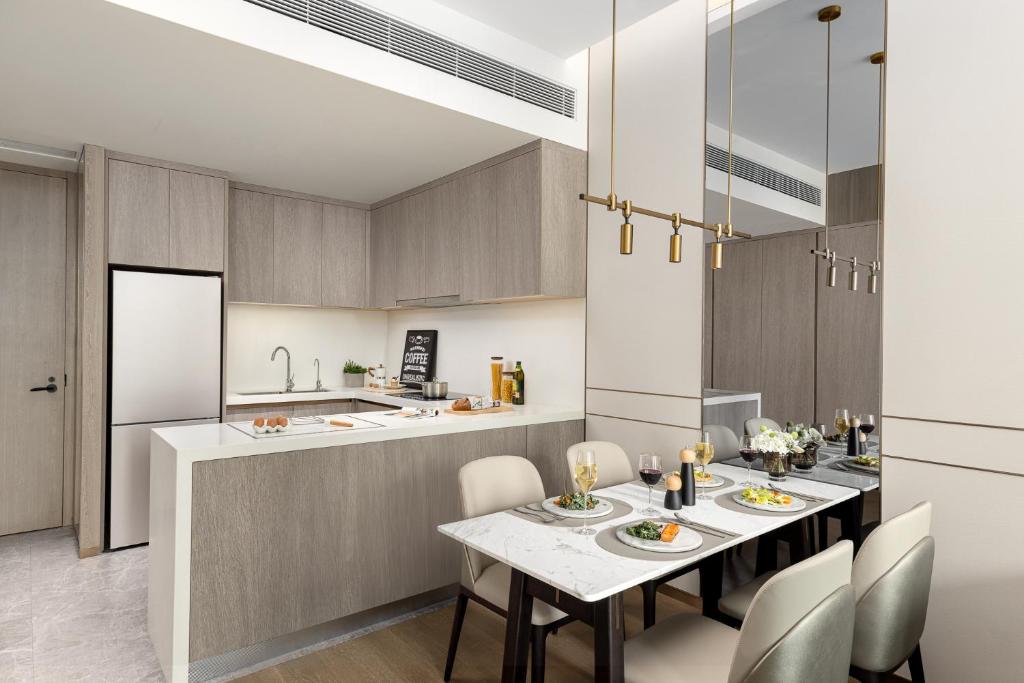 a kitchen and dining room with a table and chairs at Somerset QPlex Shenzhen in Shenzhen