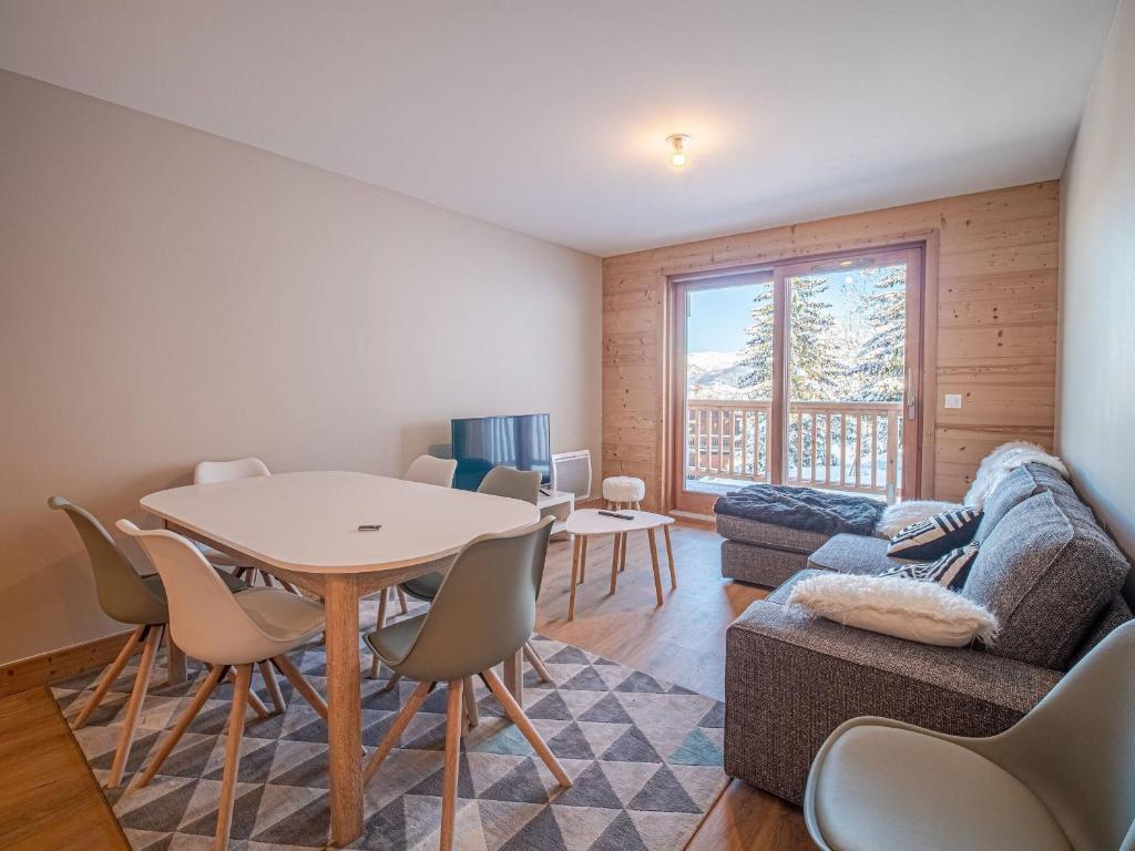 un salon avec une table et un canapé dans l'établissement Appartement neuf 6 pers, pied de pistes avec parking, Valmorel - FR-1-356-521, à Valmorel