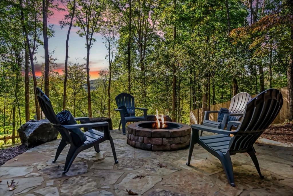 a group of chairs sitting around a fire pit at Mountain View, hot tub, fire pit, game room in Blairsville