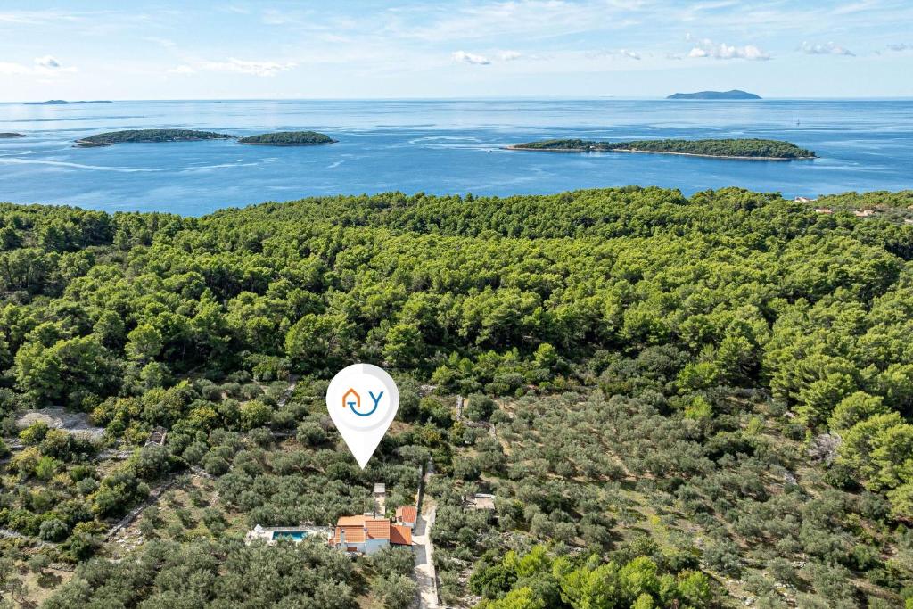 an aerial view of a hot air balloon flying over a lake at Pool House Potirna - Happy Rentals in Blato