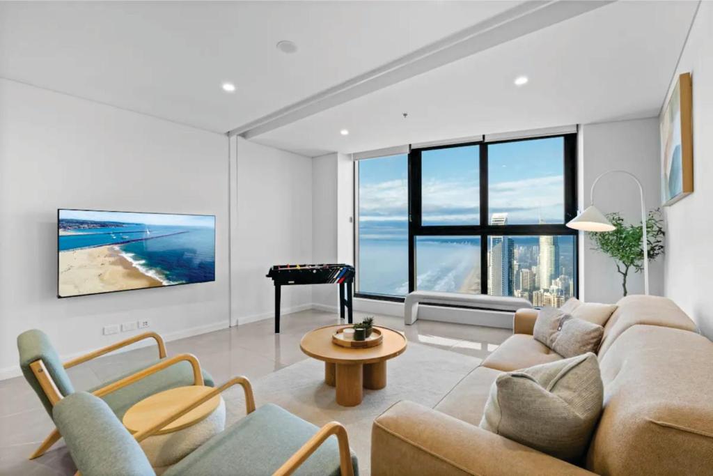 a living room with a couch and a table at Serain Residences on 88 Esplanade Surfers Paradise in Gold Coast