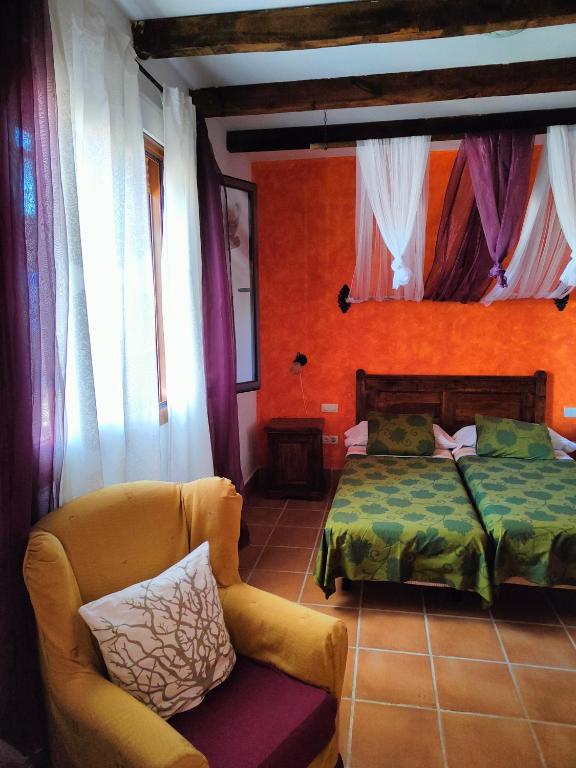 A bed or beds in a room at La Venta de las Estrellas Casas Rurales