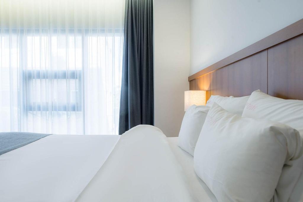 Postel nebo postele na pokoji v ubytování Davin Hotel