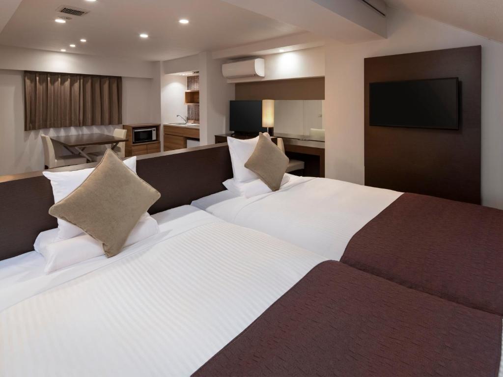 Postel nebo postele na pokoji v ubytování HOTEL MYSTAYS Iidabashi