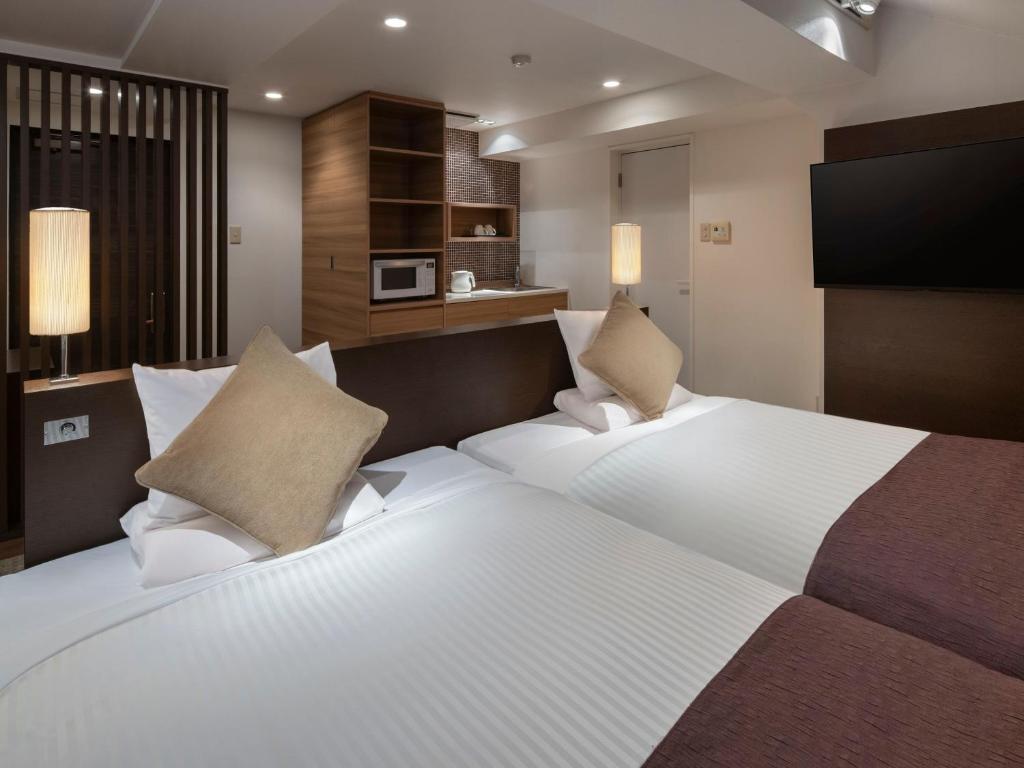 Postel nebo postele na pokoji v ubytování HOTEL MYSTAYS Iidabashi