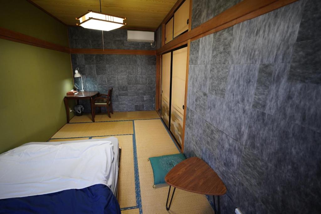 Postel nebo postele na pokoji v ubytování 白馬シェア Hakuba share