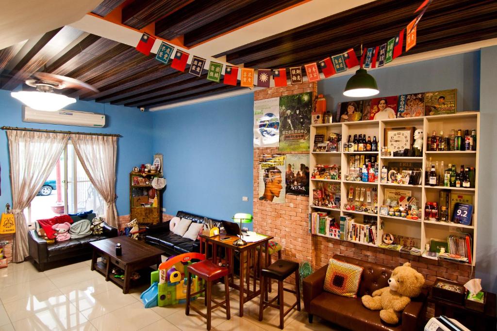 a living room with a couch and a shelf of medicines at Lane Homestay in Dayin