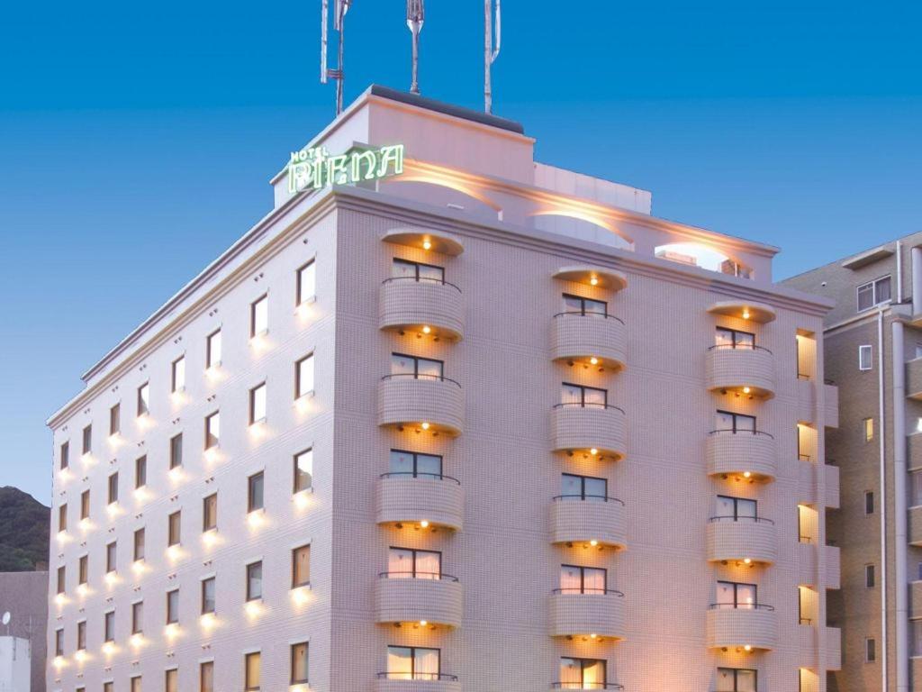 a hotel building with a sign on top of it at Hotel Piena Kobe in Kobe